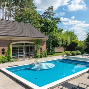 Elegant poolside setup with a modern patio, ideal for summer relaxation.